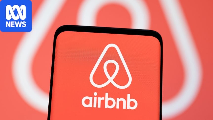 A smartphone with an Airbnb logo on it in front of the same logo being projected on a screen
