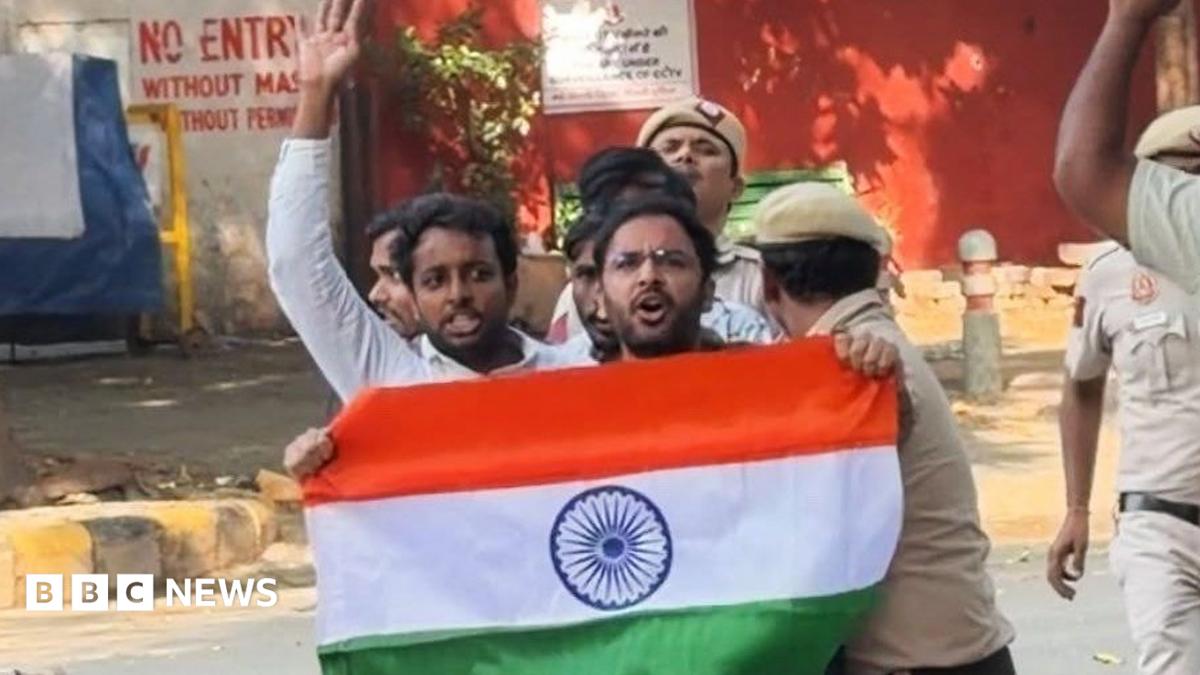 Ashutosh Ranka seen holding the Indian flag with police dragging him