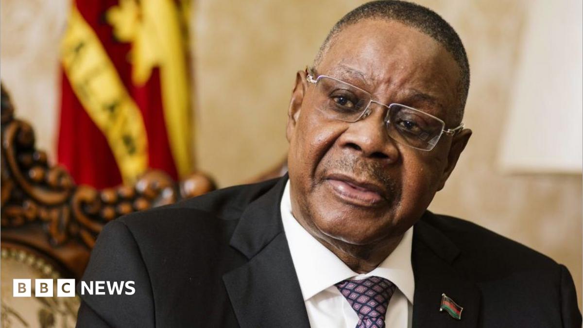Peter Mutharika wearing a black suit and dotted tie speaks during an interview in Lilongwe, Malawi