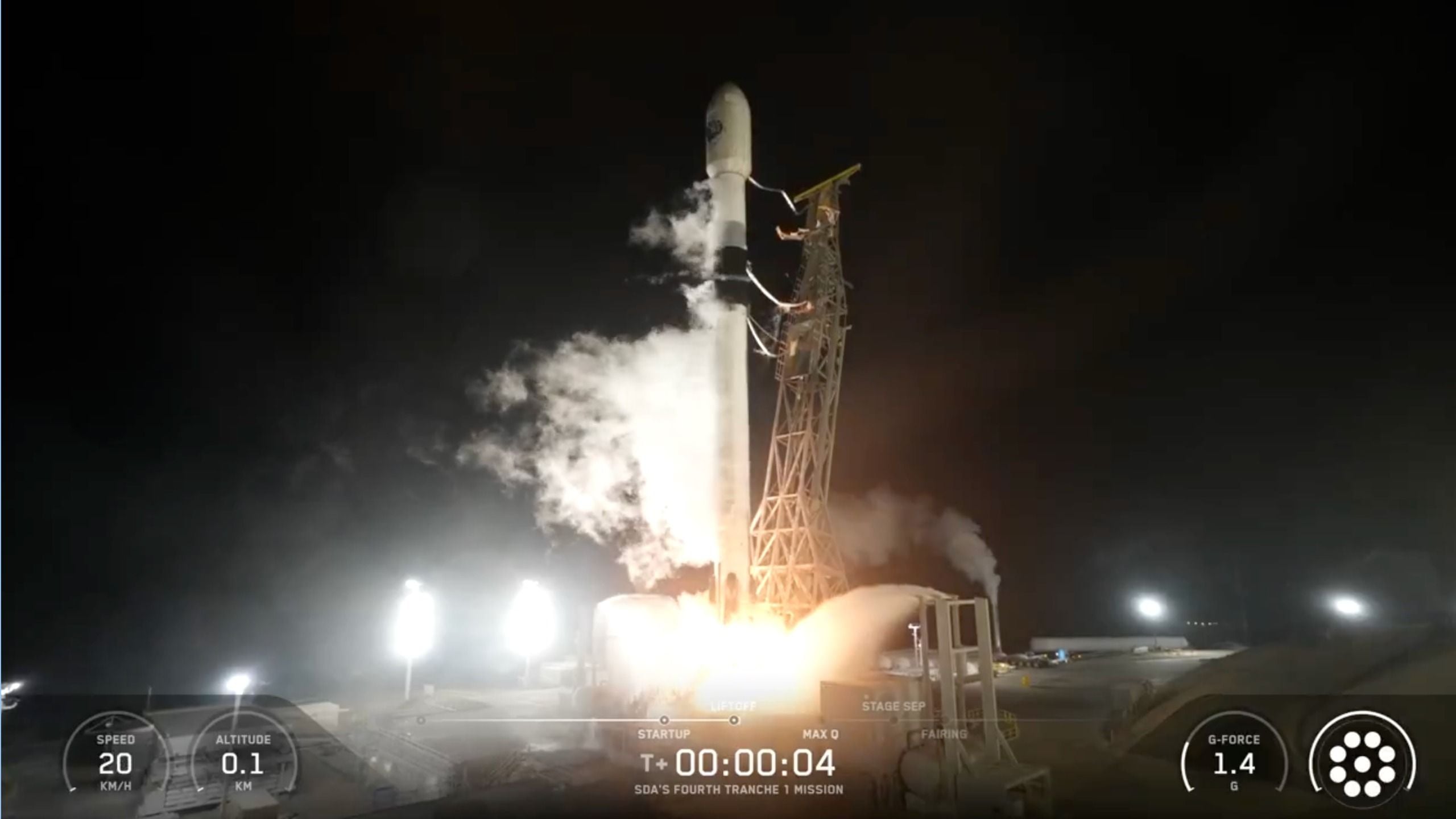 a black and white rocket launches into a night sky