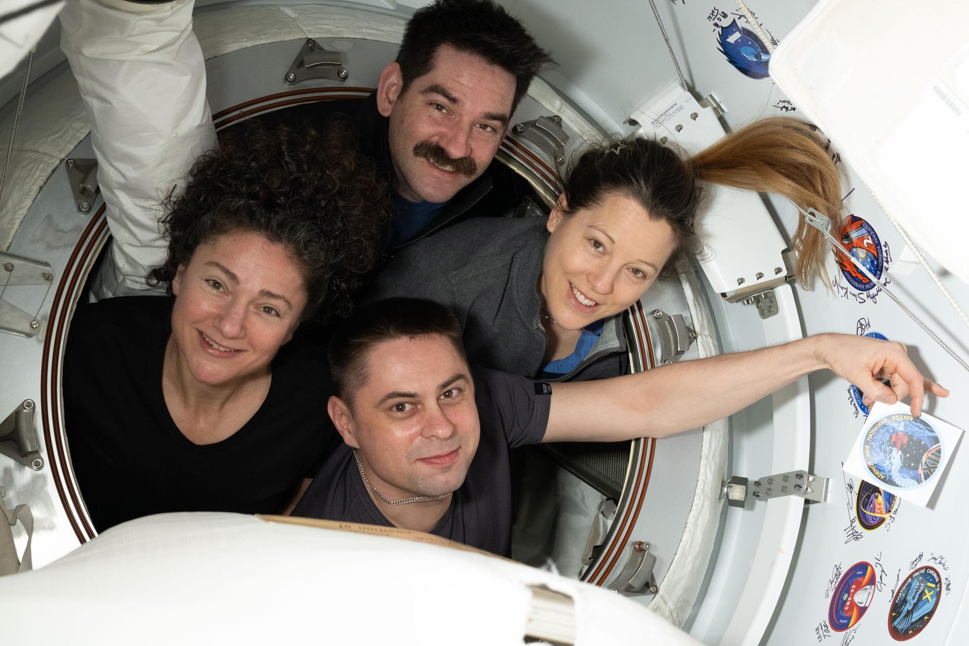 The four members of NASA's SpaceX Crew-12 mission pose for a portrait inside the vestibule between the SpaceX Dragon